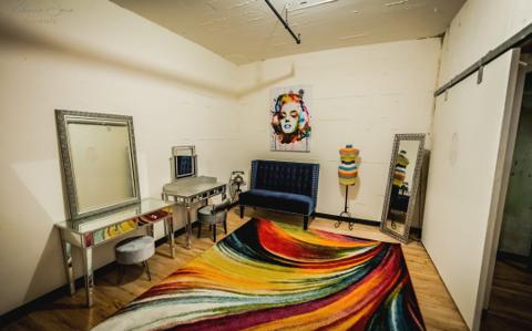 A second styled lounge with vintage mirrors and colorful decor