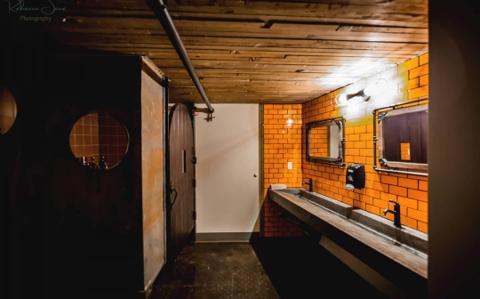The venue's restroom, finished in orange subway tile
