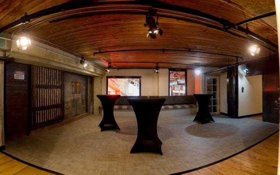 A lounge area with cocktail tables and bench seating
